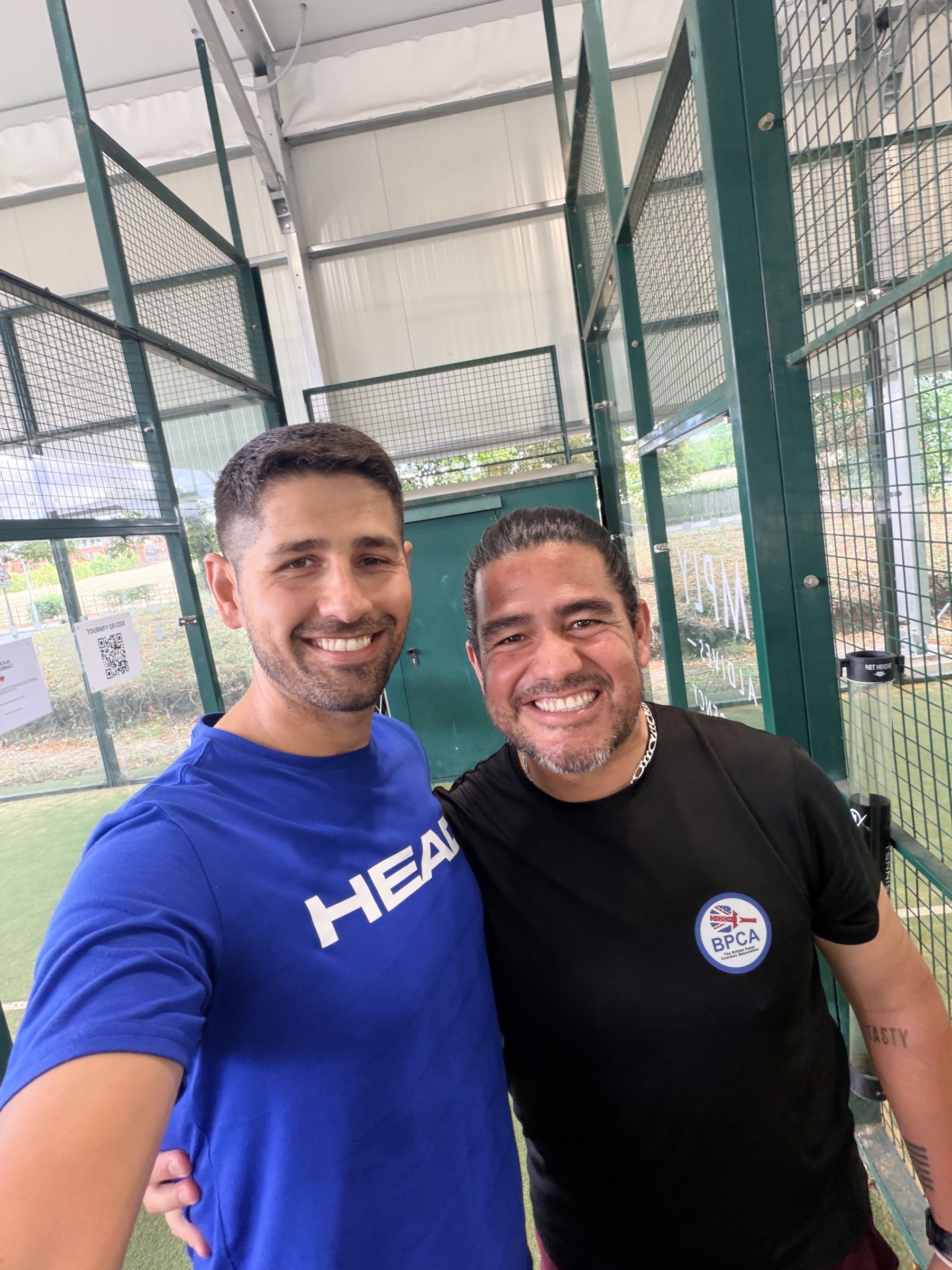Mark Hunter with a fellow padel coach at an indoor padel court